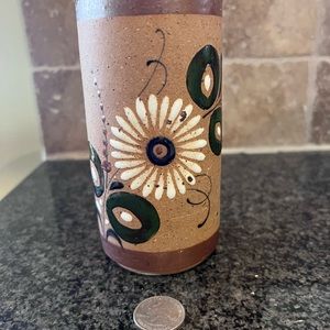 Mexican pottery vase with painted flower.